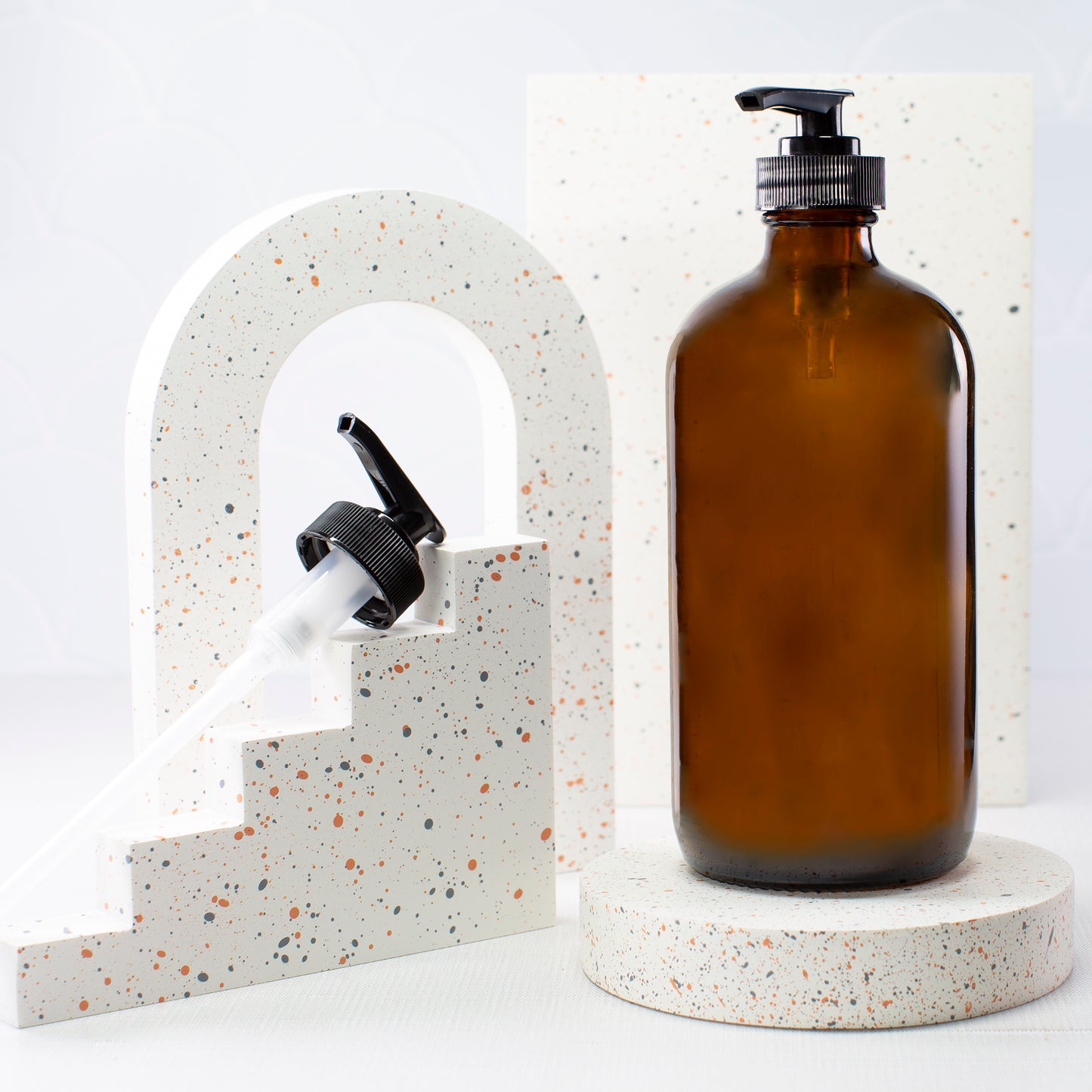 16 oz Amber Glass Bottle with 28-400 Black Saddle Pump