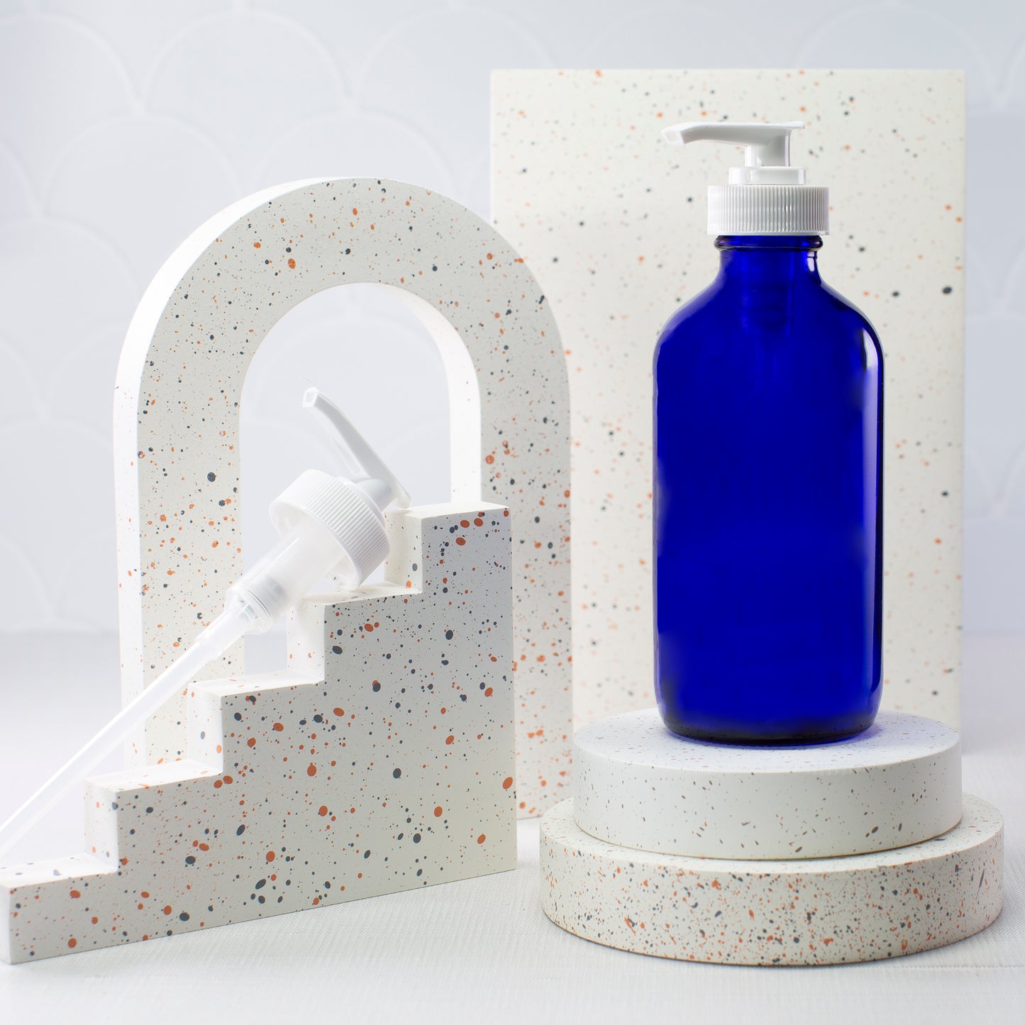 16 oz Blue Glass Boston Round Bottle with 28-400 White Saddle Pump