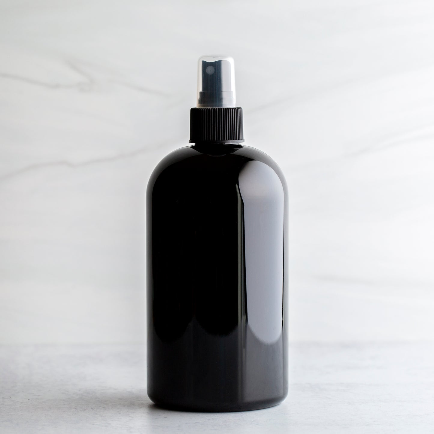 16 oz Black PET Boston Round Bottle with 24-410 Black Fine Mist Sprayer