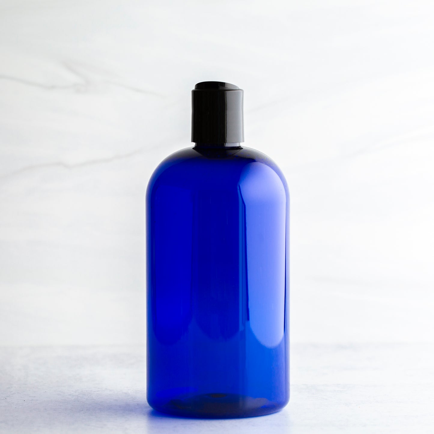 16 oz Blue Boston Round Bottle with 24-410 Black Disc Cap