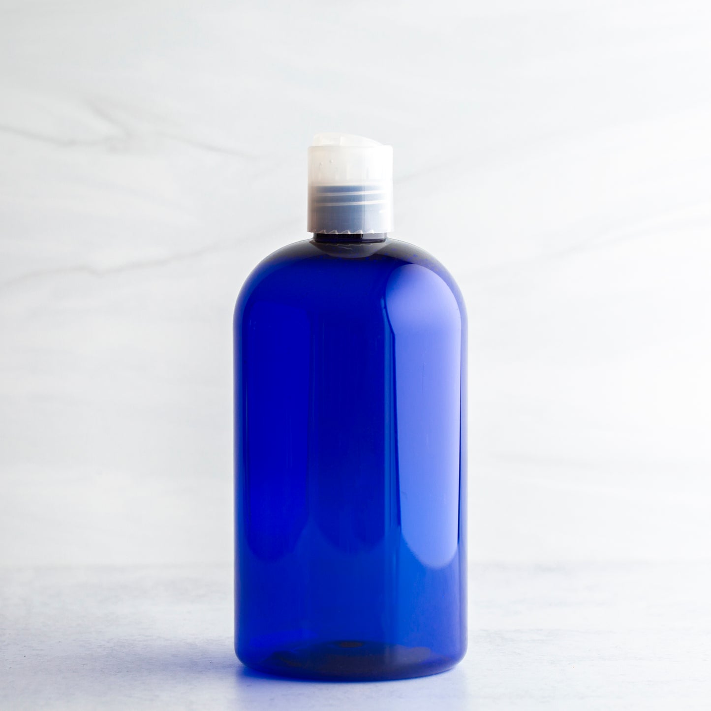 16 oz Blue Boston Round Bottle with 24-410 Natural Disc Cap