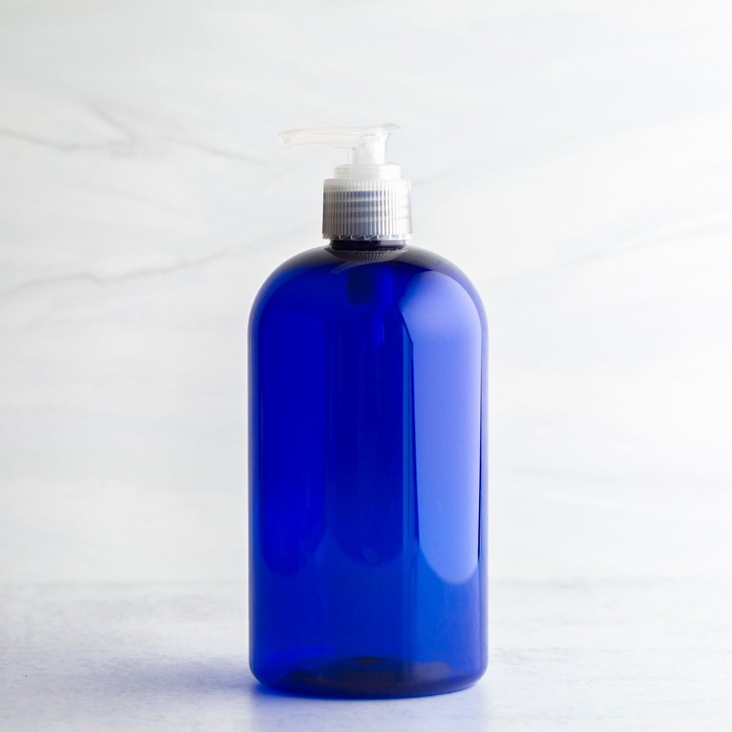 16 oz Blue Boston Round Bottle with 24-410 Natural Saddle Pump