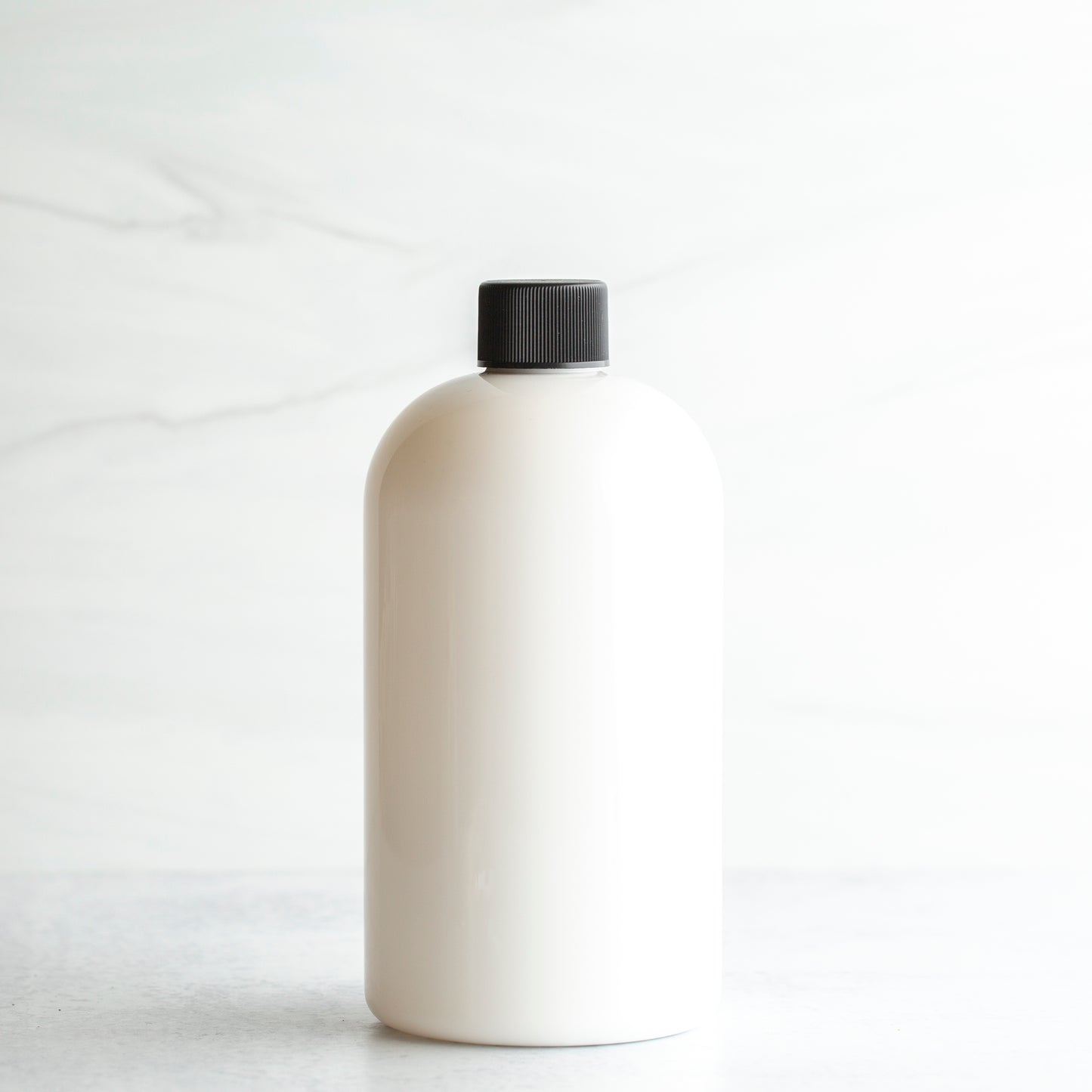 16 oz White PET Boston Round Bottle with 24-410 Black Ribbed Cap