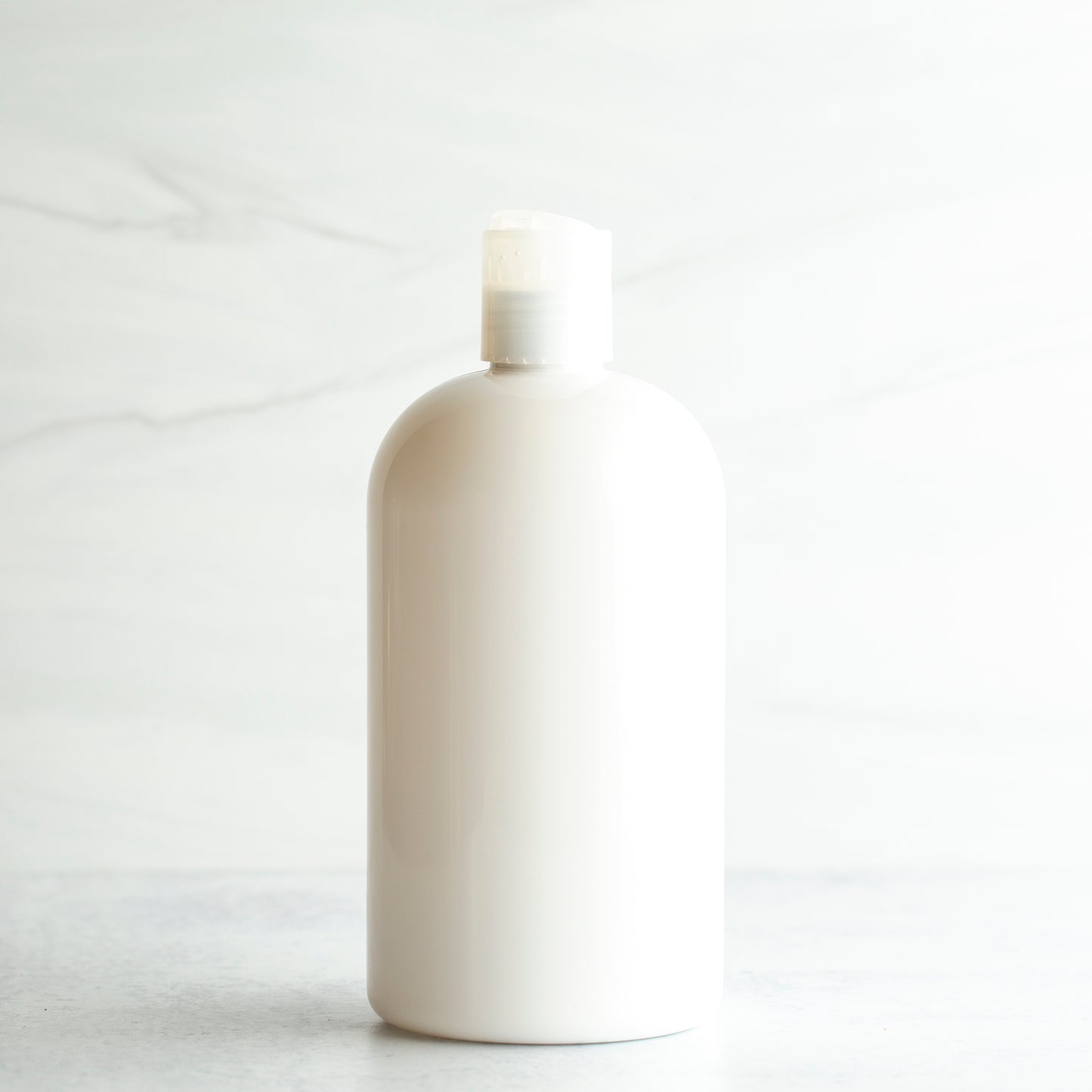 16 oz White PET Boston Round Bottle with 24-410 Natural Disc Cap