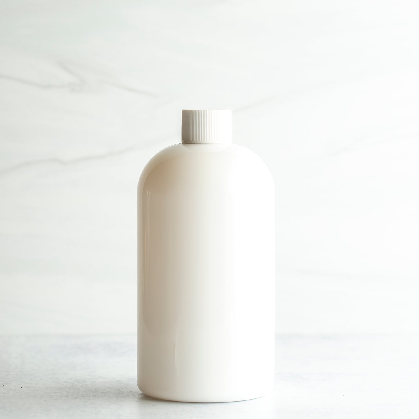 16 oz White PET Boston Round Bottle with 24-410 White Ribbed Cap