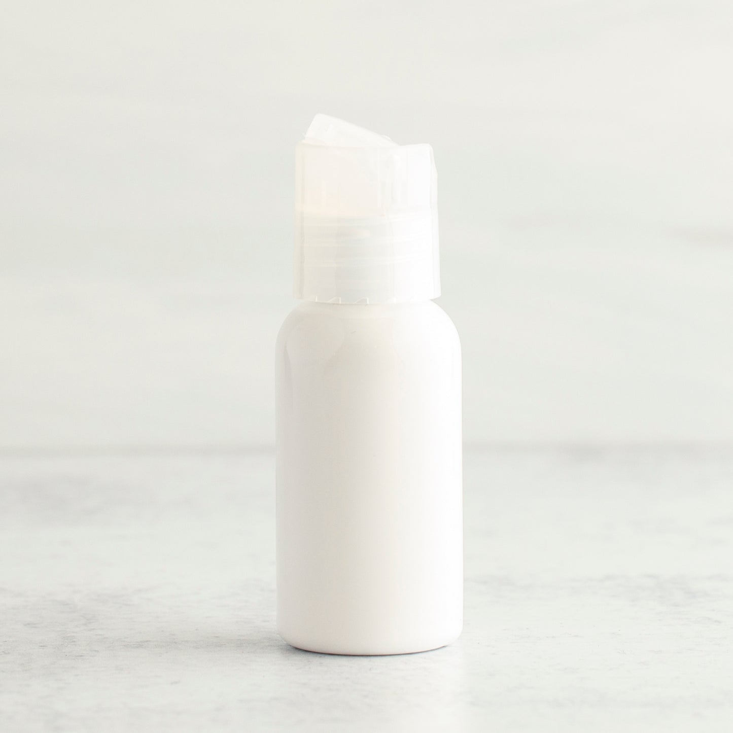 1 oz White PET Boston Round Bottle with 20-410 Natural Disc Cap