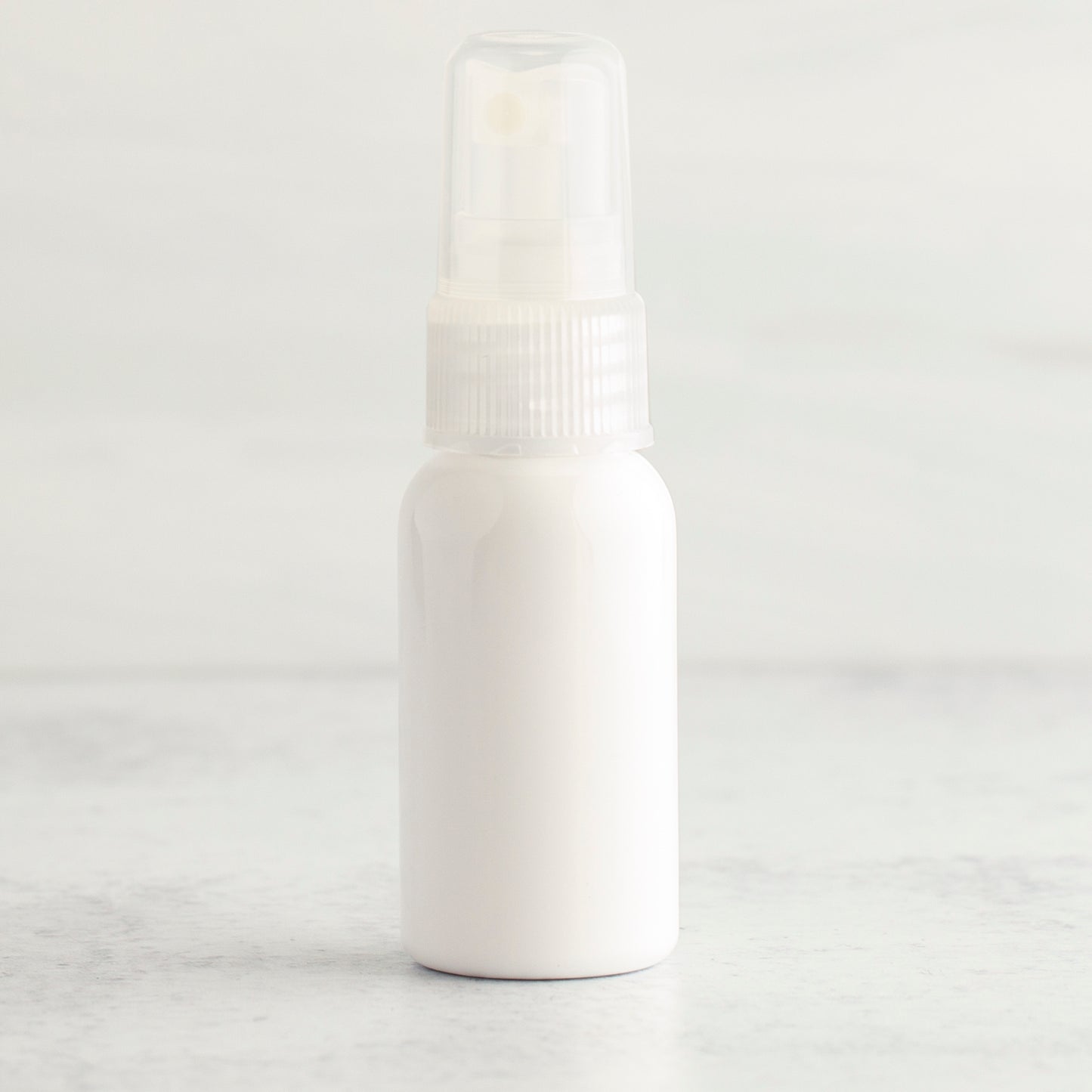 1 oz White PET Boston Round Bottle with 20-410 Natural Fine Mist Sprayer