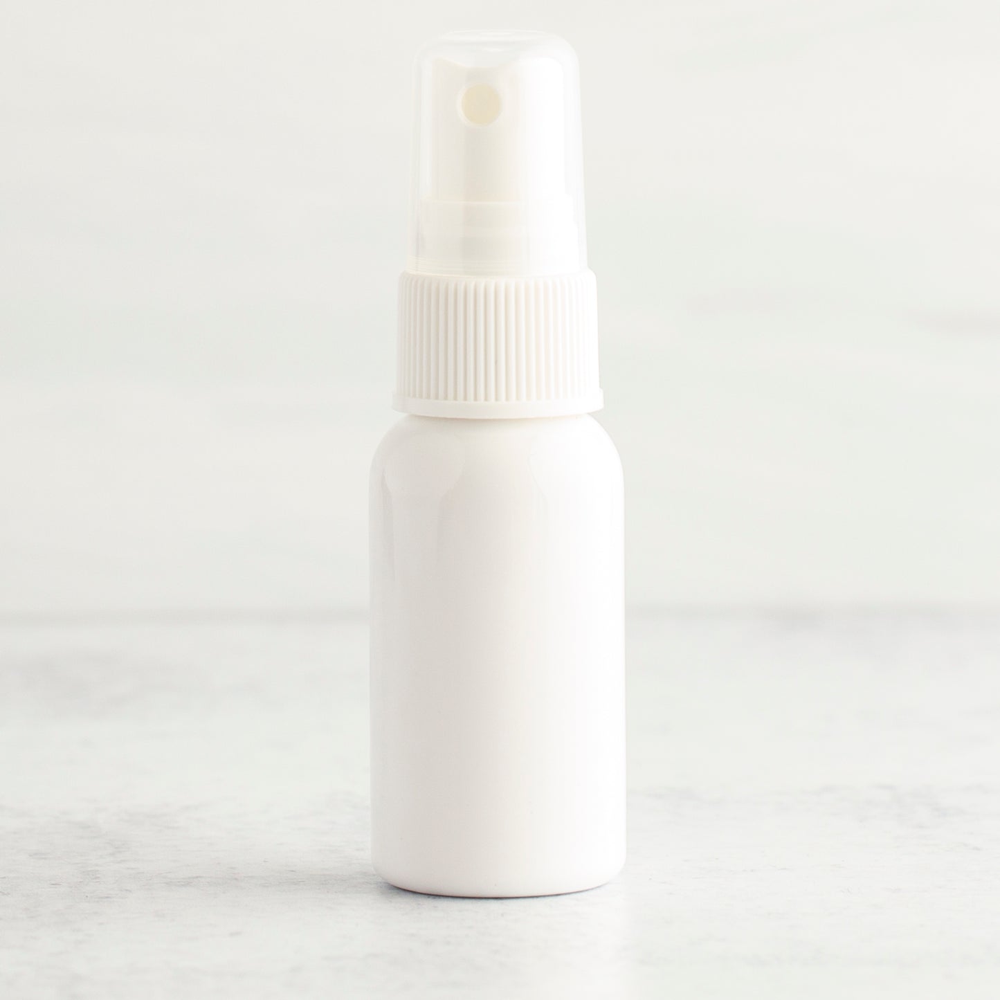 1 oz White PET Boston Round Bottle with 20-410 White Fine Mist Sprayer