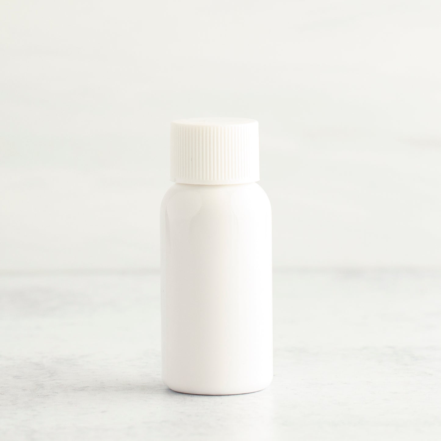 1 oz White PET Boston Round Bottle with 20-410 White Ribbed Cap