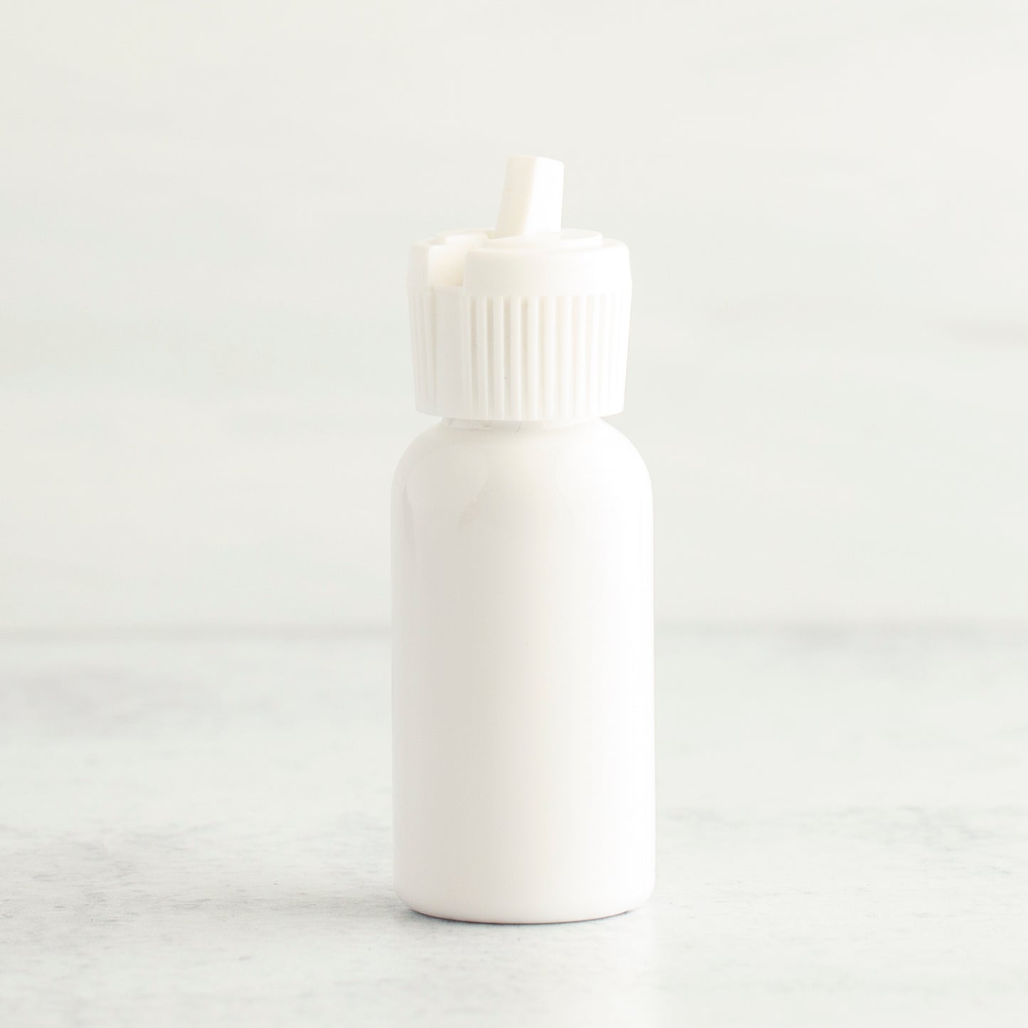1 oz White PET Boston Round Bottle with 20-410 White Turret Cap