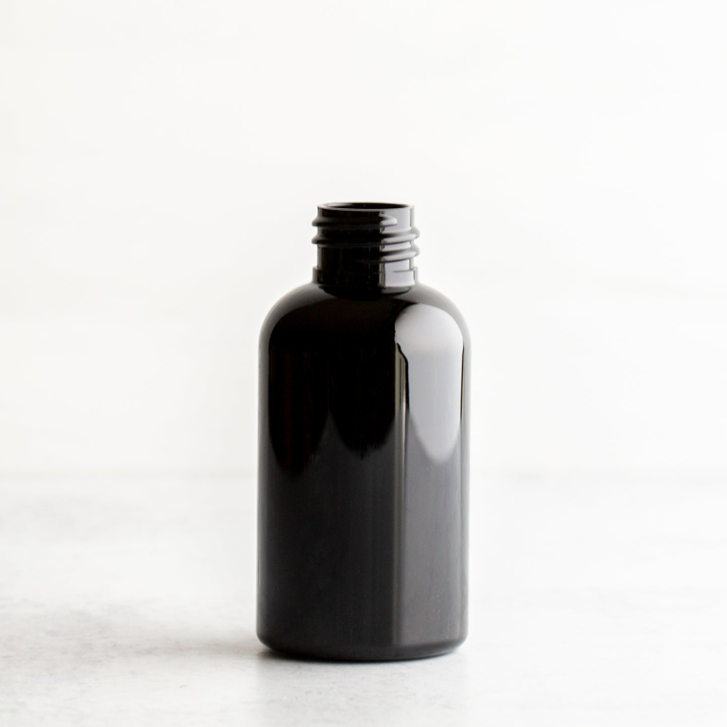 2 oz Black PET Boston Round Bottle Without Closure