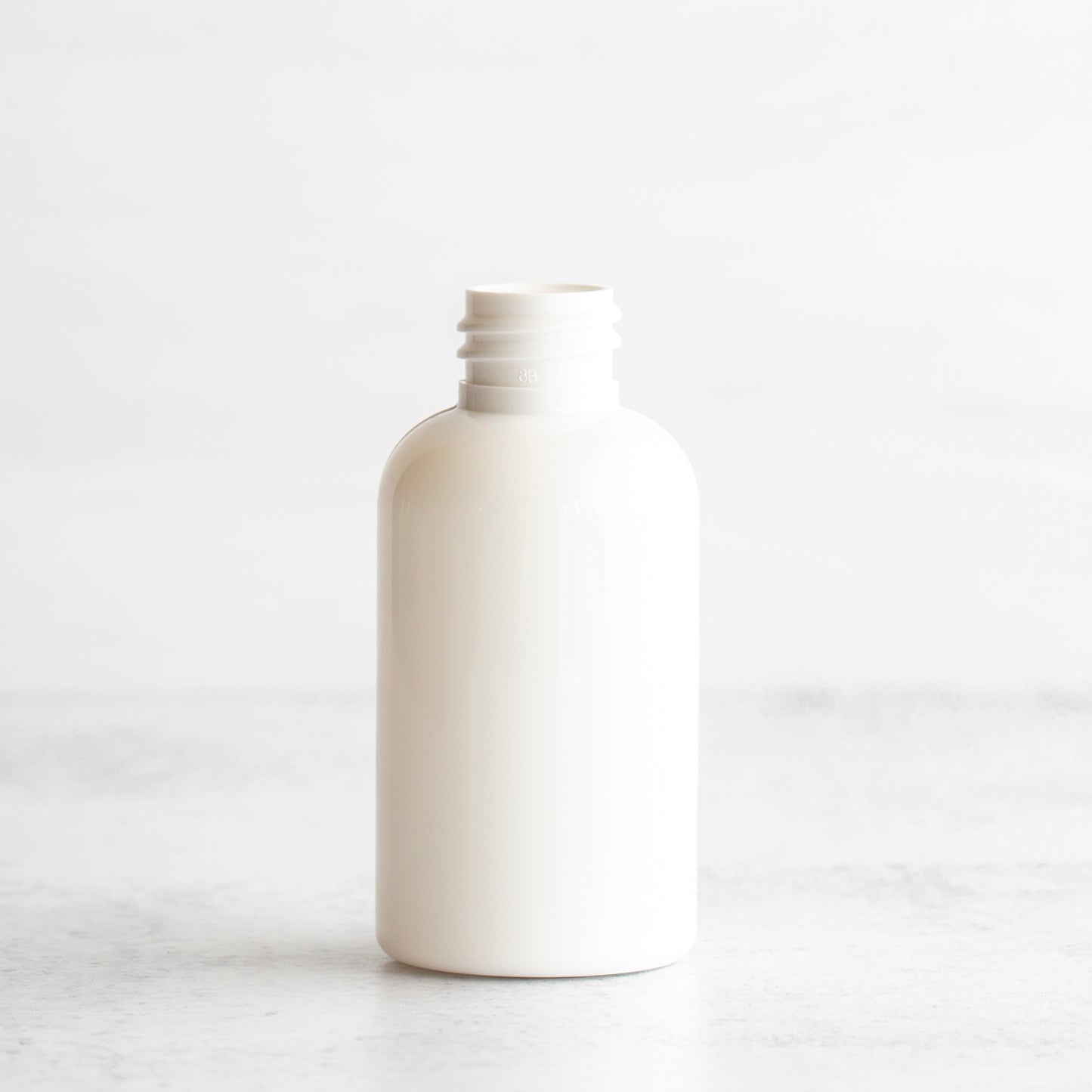 2 oz White PET Boston Round Bottle Without Closure