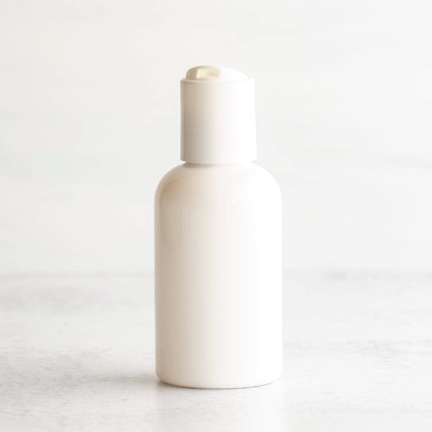 2 oz White PET Boston Round Bottle with 20-410 White Disc Cap