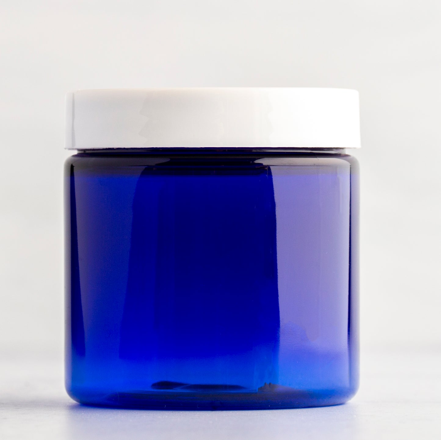 4 oz Blue Straight Side Plastic Jar with White Flat Gloss Cap