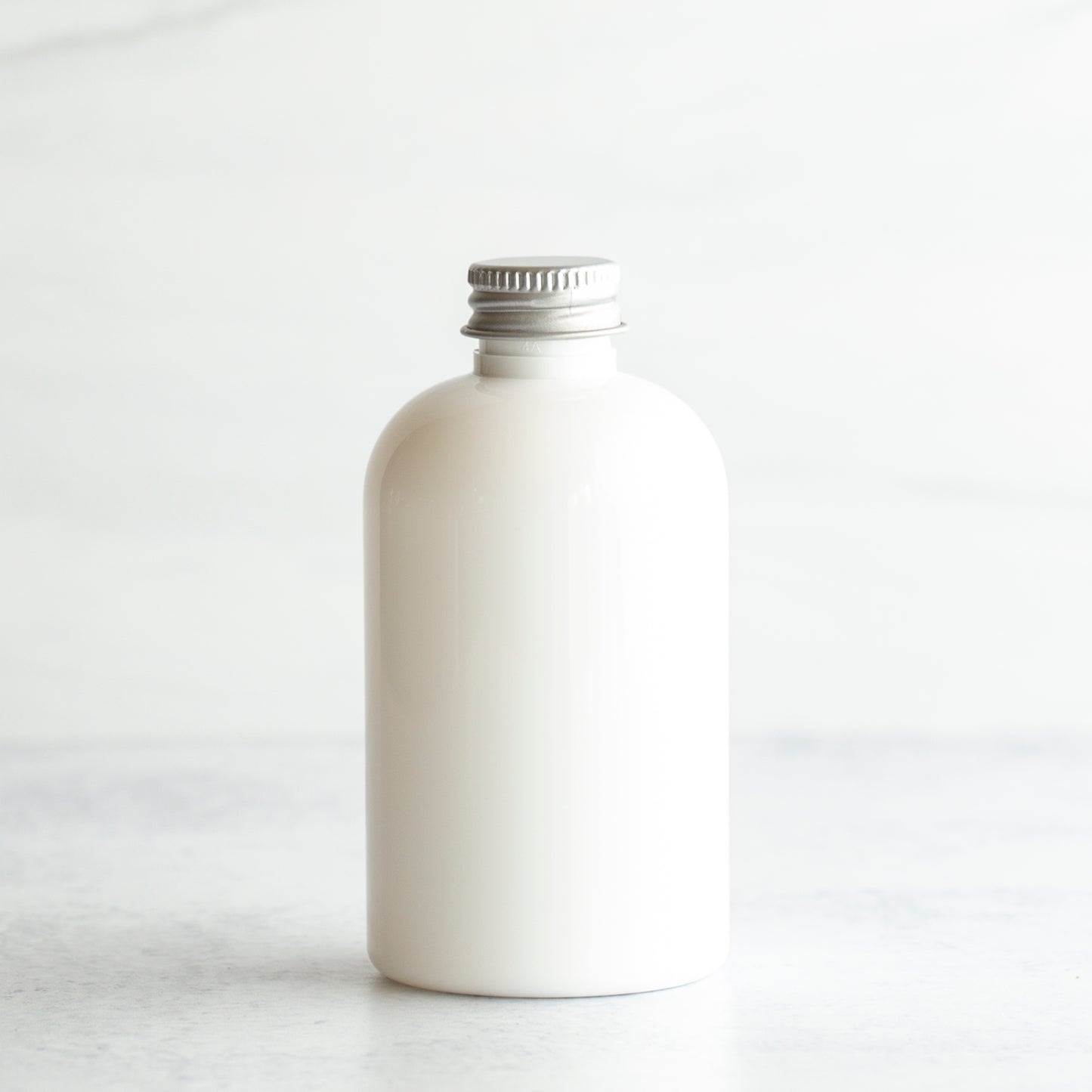 4 oz White PET Boston Round Bottle with 20-410 Aluminum Cap