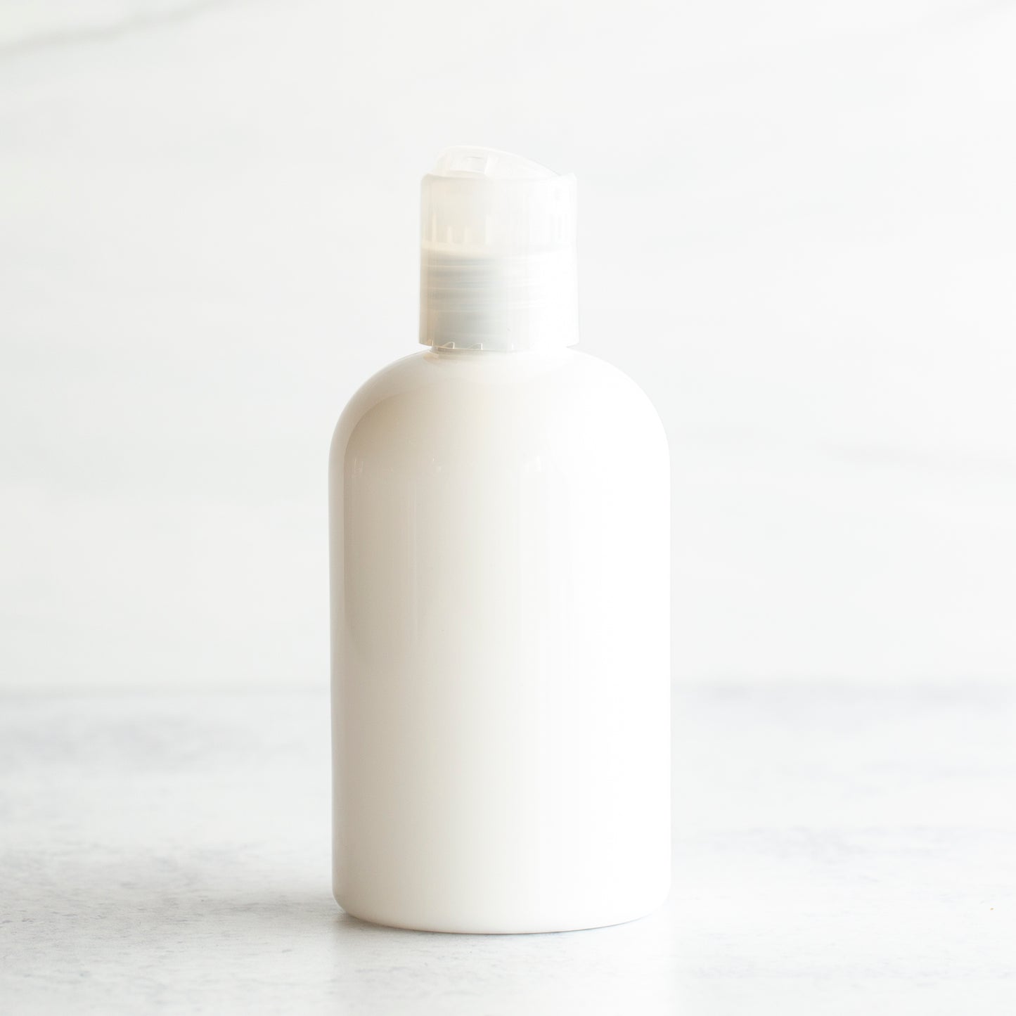 4 oz White PET Boston Round Bottle with 20-410 Natural Disc Cap
