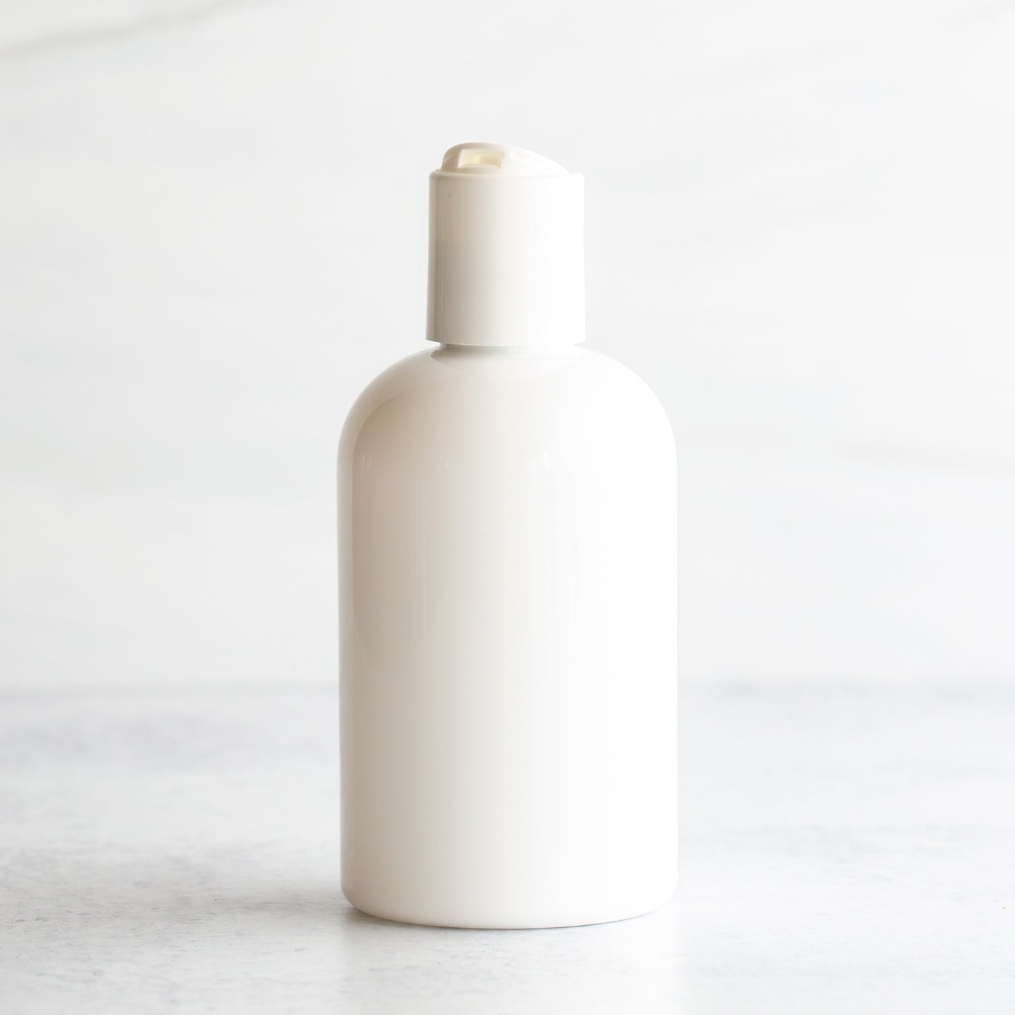 4 oz White PET Boston Round Bottle with 20-410 White Disc Cap