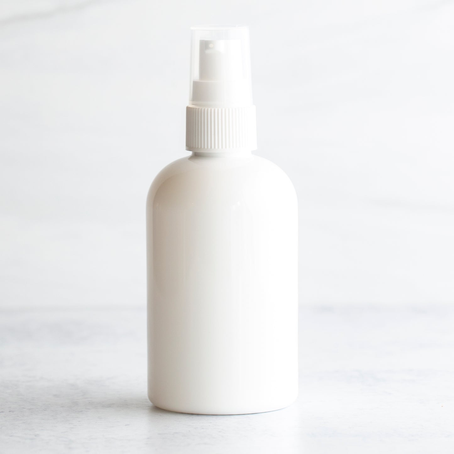 4 oz White PET Boston Round Bottle with 20-410 White Treatment Pump