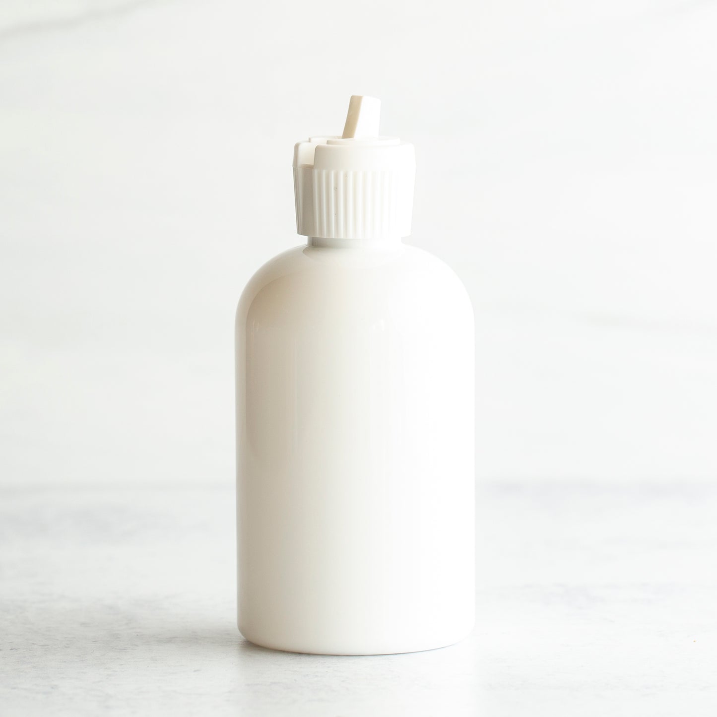 4 oz White PET Boston Round Bottle with 20-410 White Turret Cap