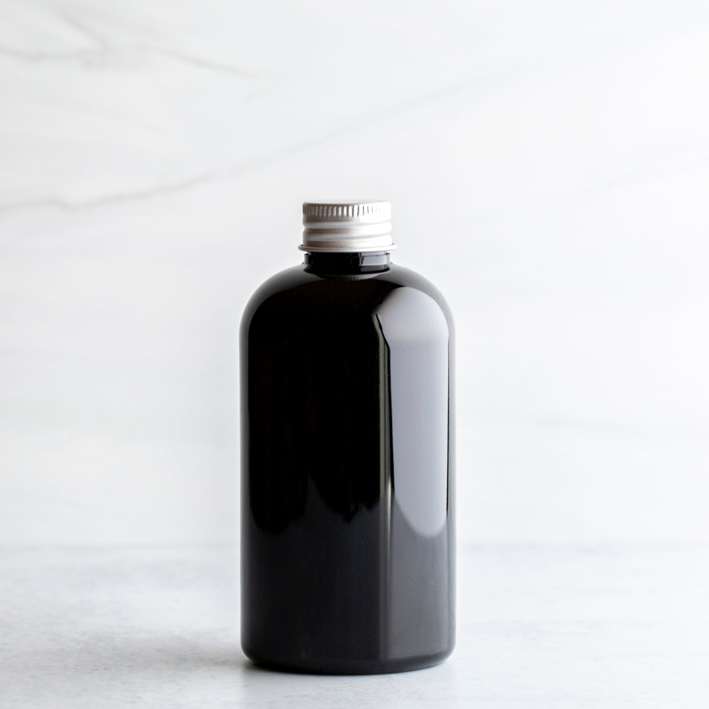 8 oz Black PET Boston Round Bottle with 24-410 Aluminum Cap