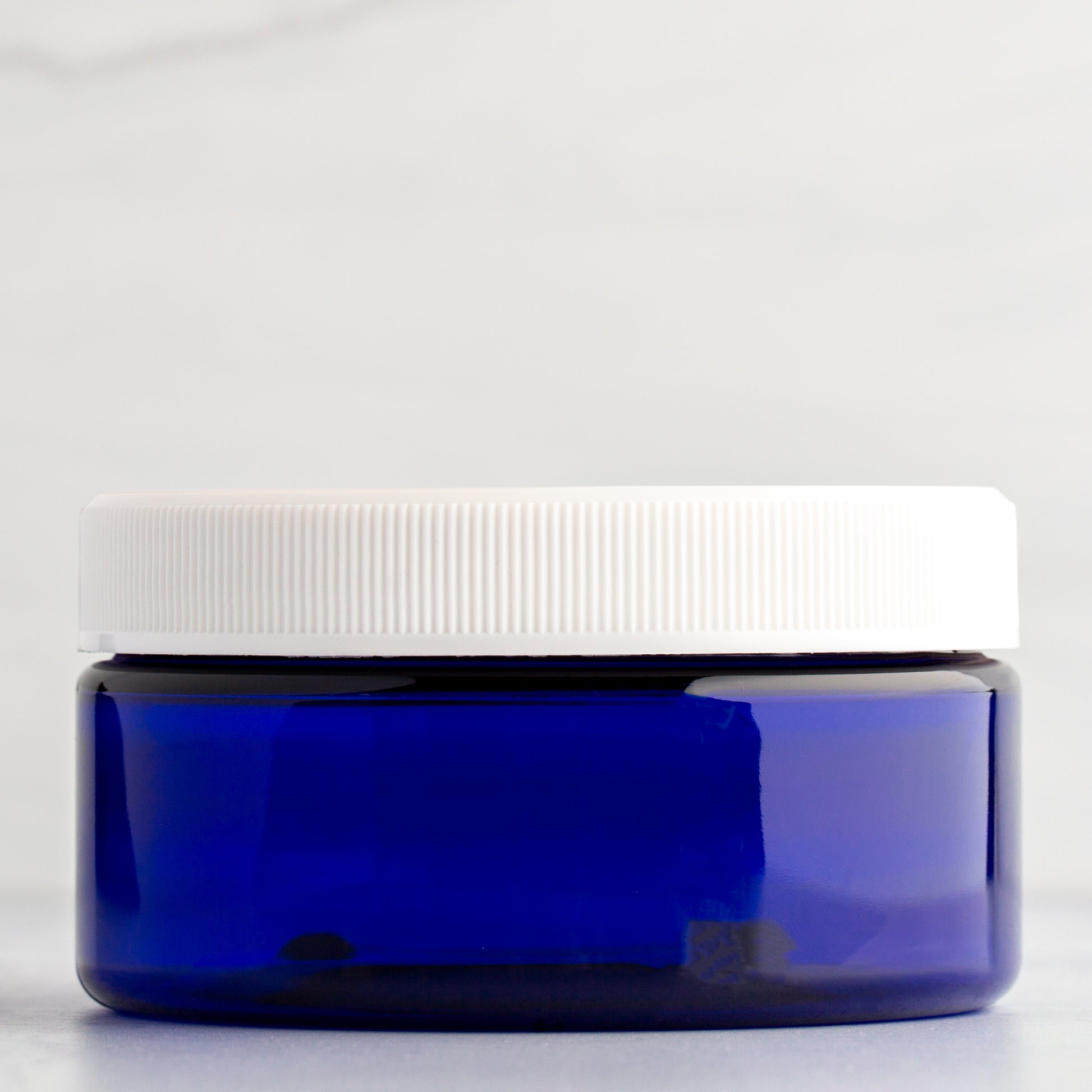 8 oz Blue Shallow Plastic Jar with White Ribbed Cap