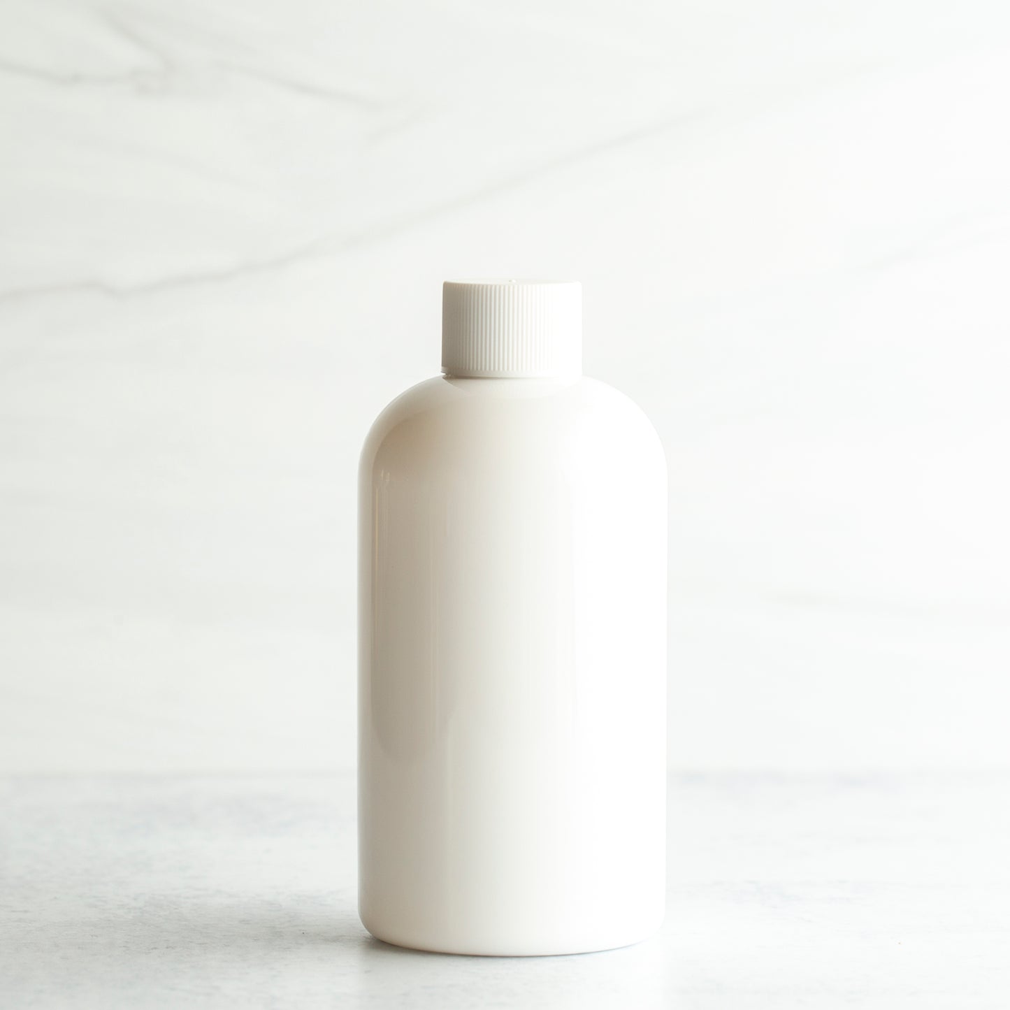 8 oz White PET Boston Round Bottle with 24-410 White Ribbed Cap