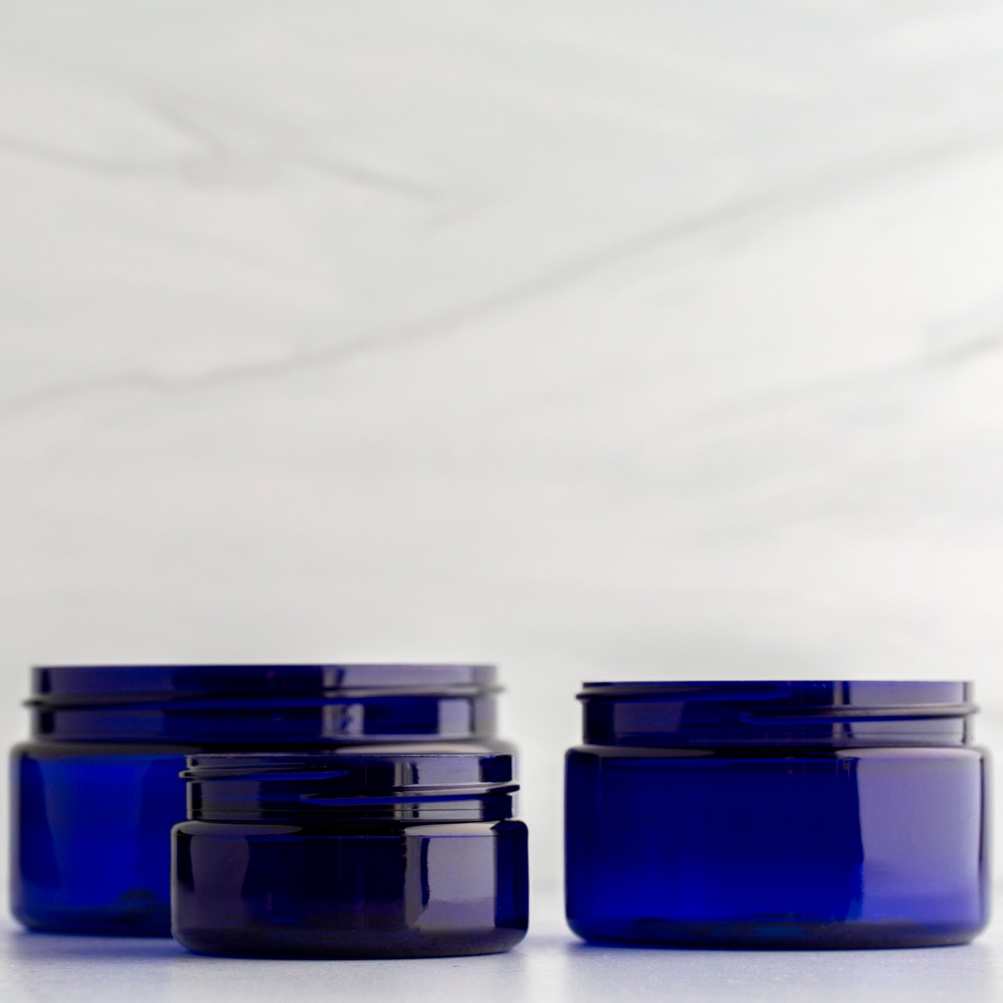 2 oz Blue Shallow Jar with 58-400 Black Dome Cap
