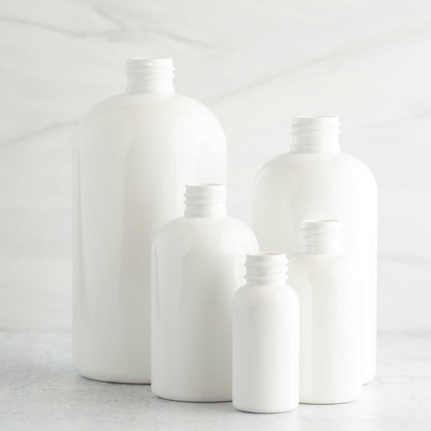 2 oz White PET Boston Round Bottle with 20-410 Aluminum Cap