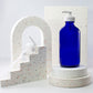 16 oz Blue Glass Boston Round Bottle with 28-400 White Saddle Pump