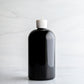 16 oz Black PET Boston Round Bottle with 24-410 White Turret Cap