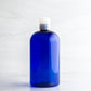 16 oz Blue Boston Round Bottle with 24-410 Natural Disc Cap