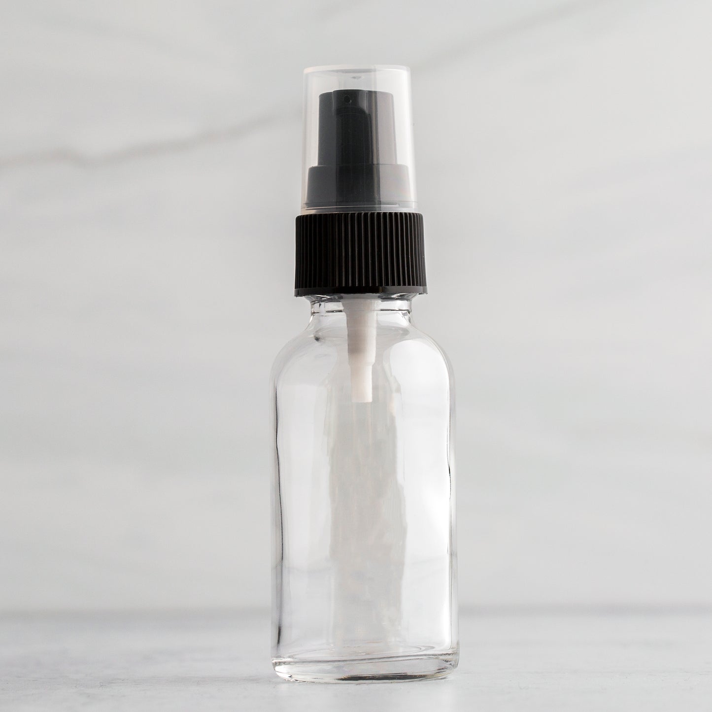 1 oz Clear Glass Bottle with Black Treatment Pump