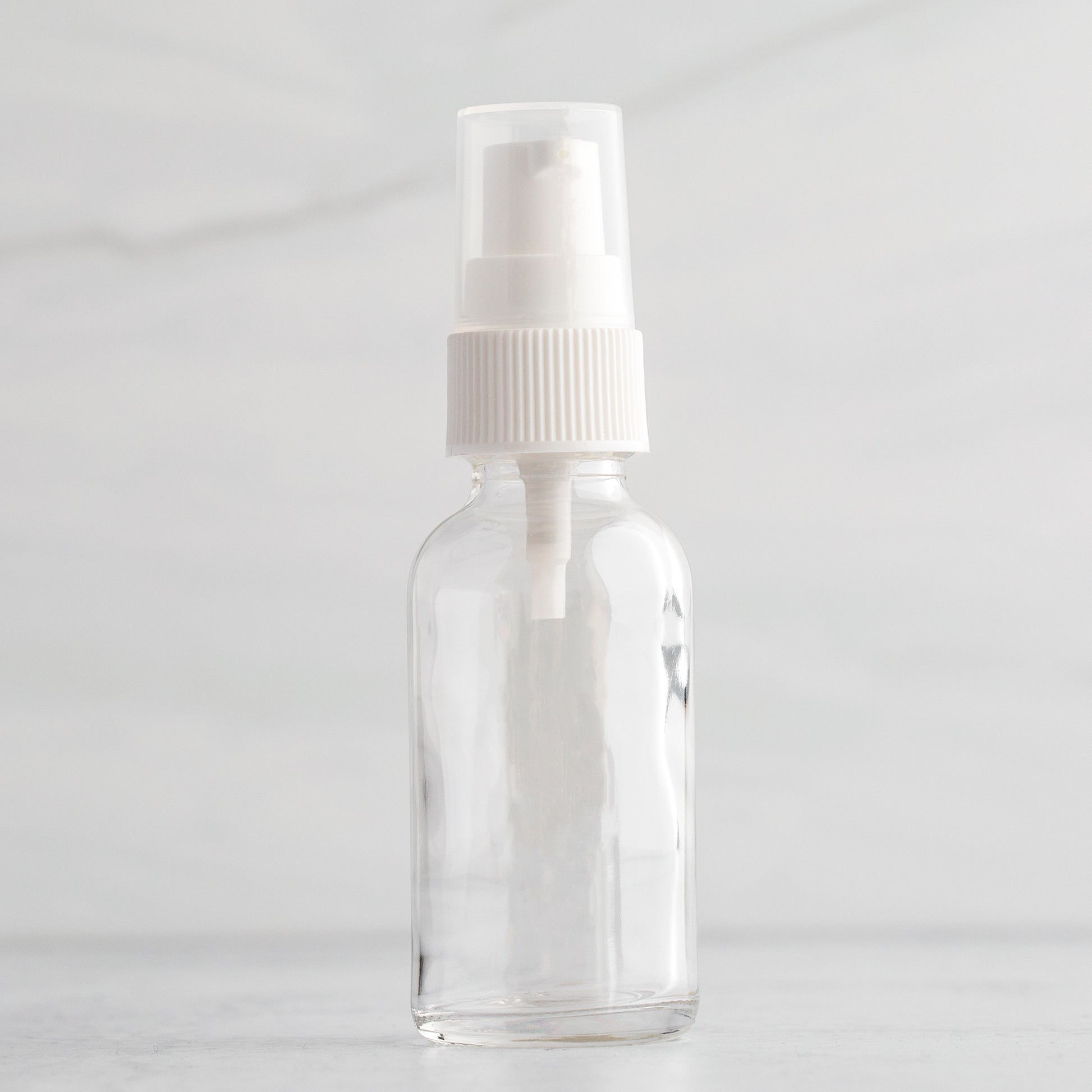 1 oz Clear Glass Bottle with White Treatment Pump