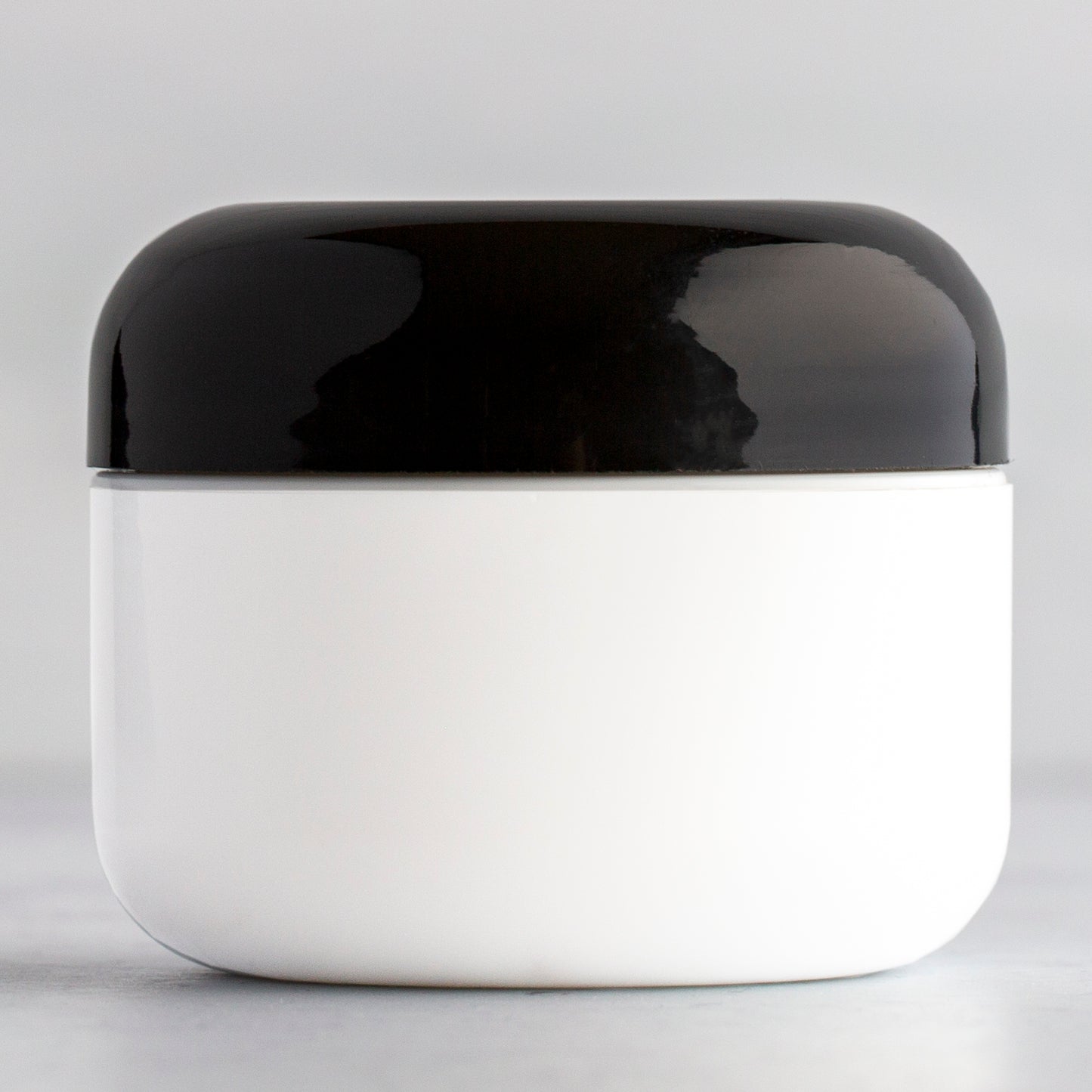 1 oz White Round Base Plastic Jar with Black Dome Cap