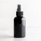 2 oz Black PET Boston Round Bottle with 20-410 Black Treatment Pump