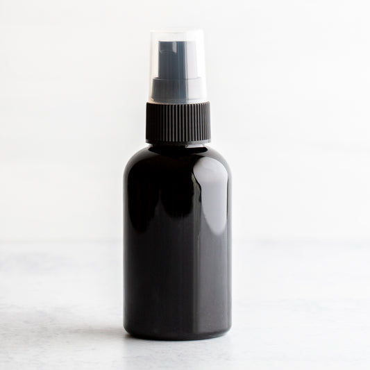 2 oz Black PET Boston Round Bottle with 20-410 Black Treatment Pump