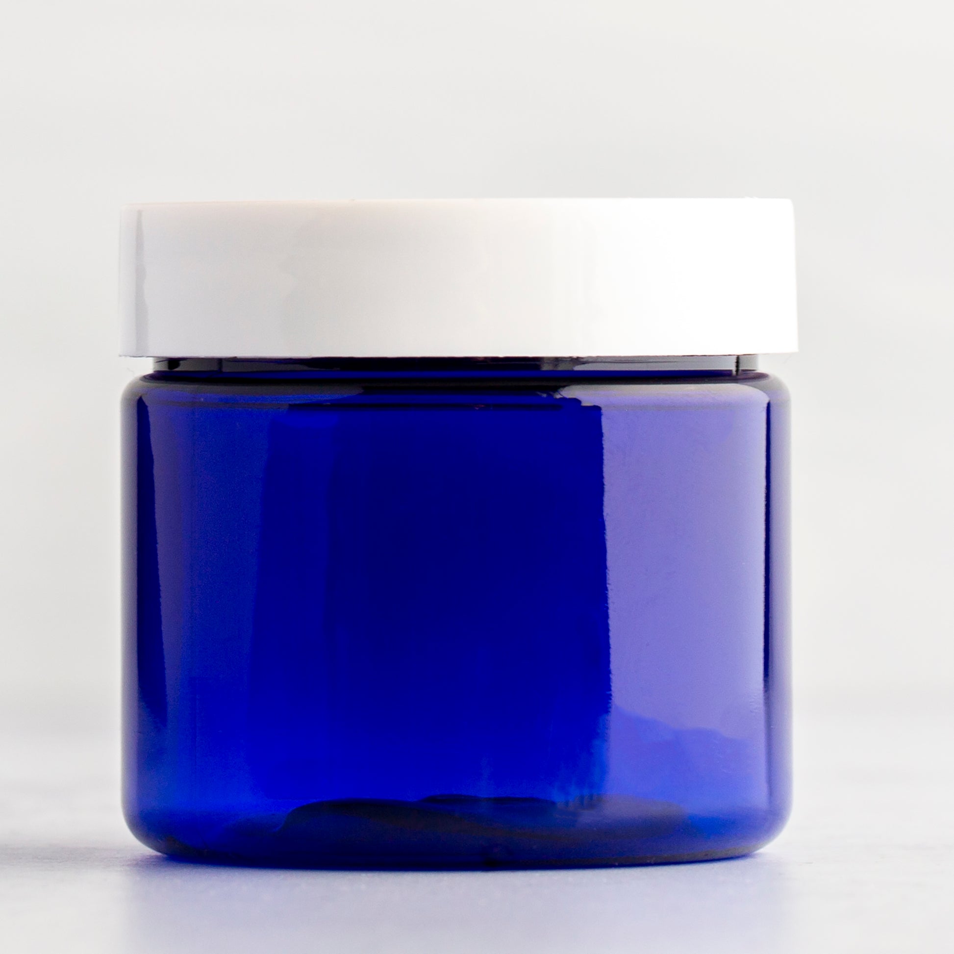 2 oz Blue Straight Side Plastic Jar with White Flat Gloss Cap