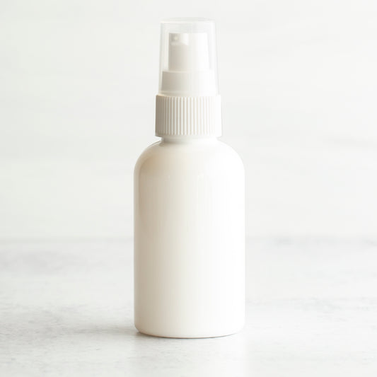 2 oz White PET Boston Round Bottle with 20-410 White Treatment Pump