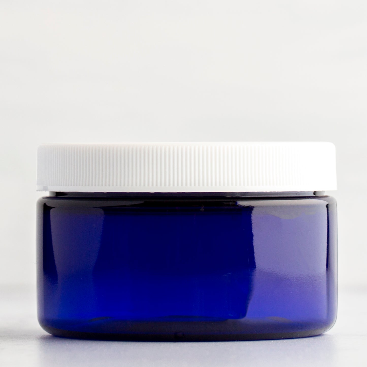 4 oz Blue Shallow Plastic Jar with White Ribbed Cap