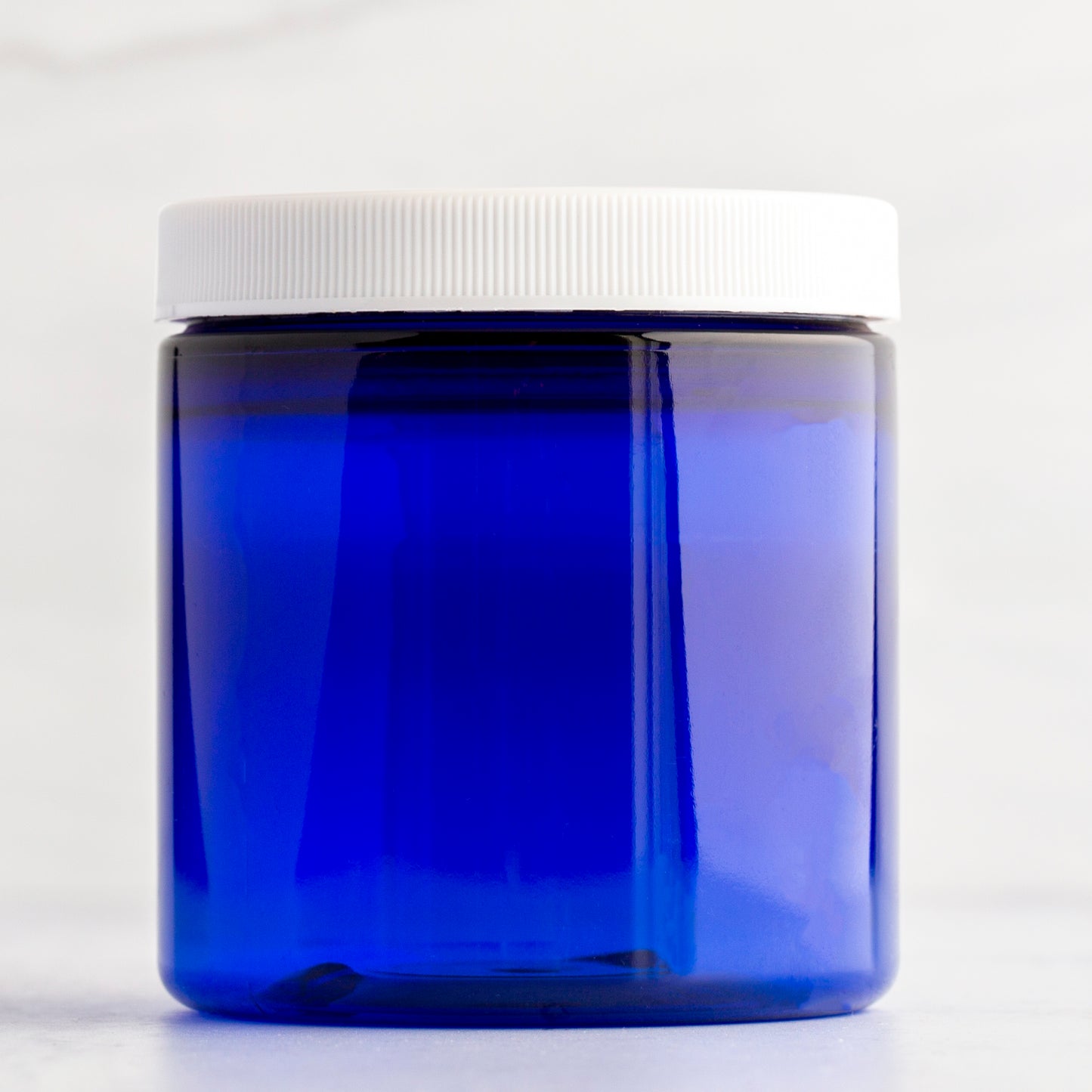 8 oz Blue Straight Side Plastic Jar with White Ribbed Cap