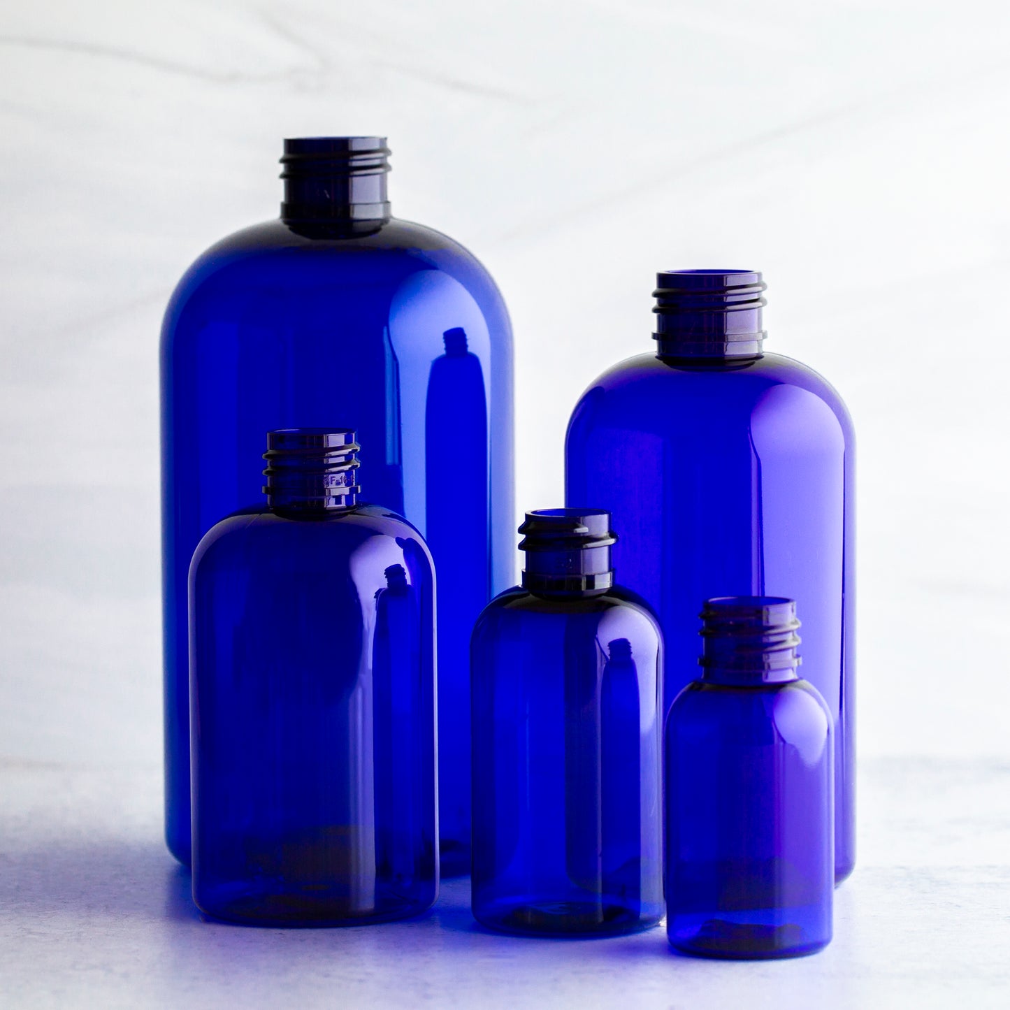 16 oz Blue Boston Round Bottle with 24-410 Natural Mister