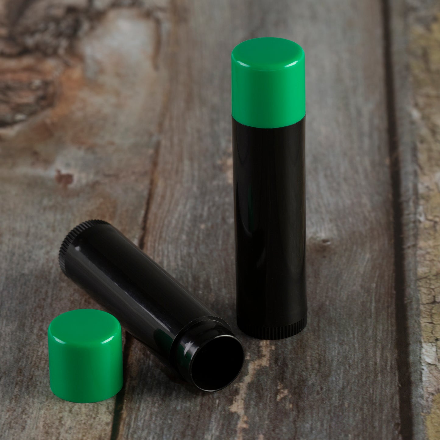 black lip balm tube green cap