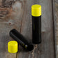 black lip balm tube yellow cap