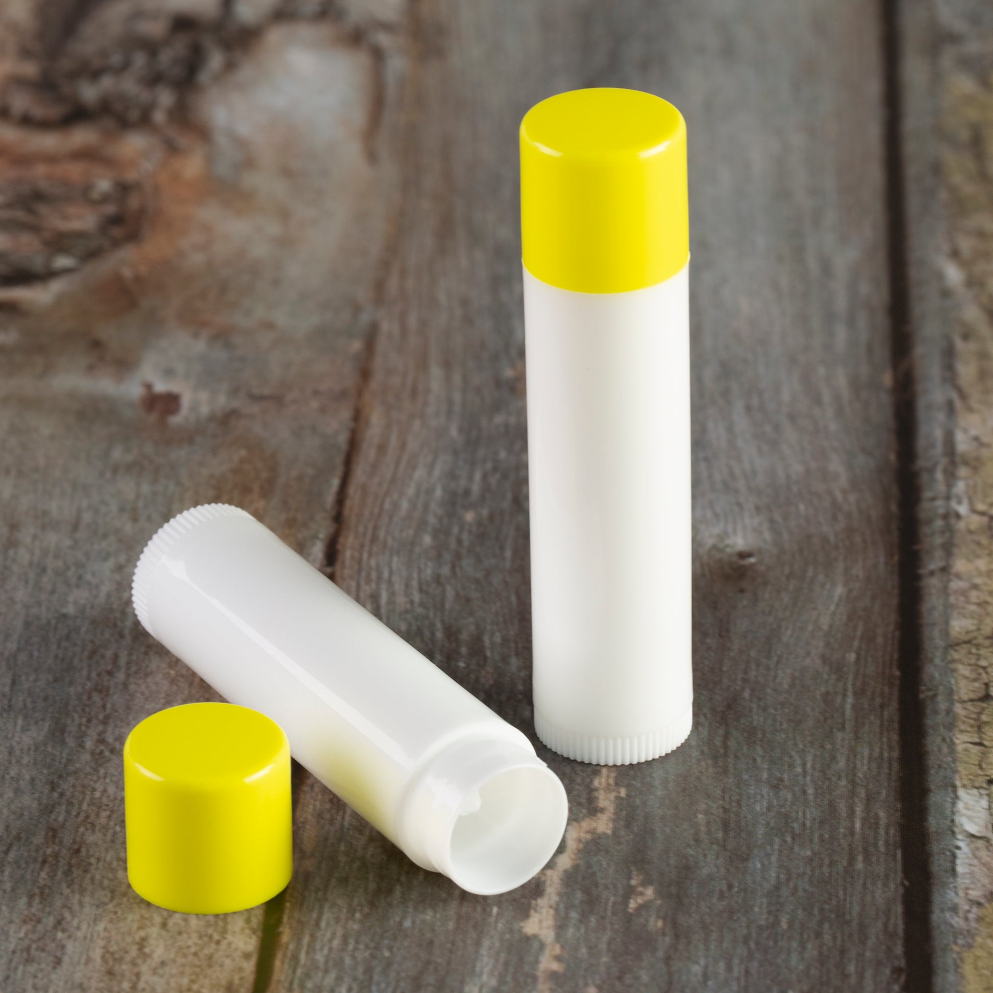 white lip balm tube yellow cap